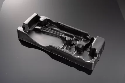 Black plastic blister pack with molded compartments