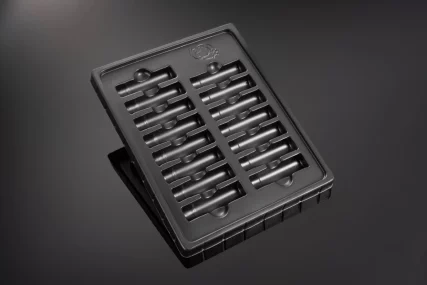 Black plastic tray with multiple slots