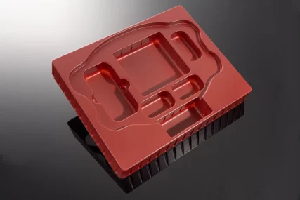 Red plastic blister packaging mold with compartments